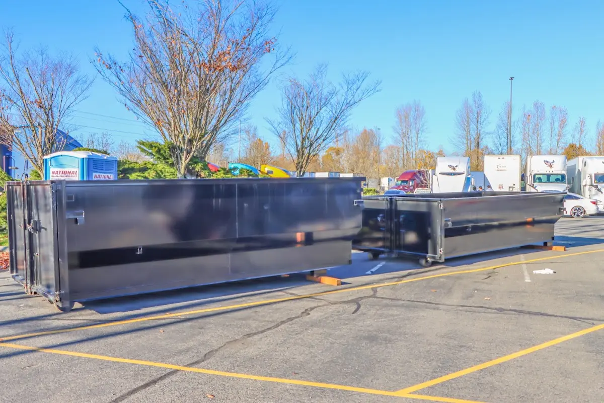 Professional dumpster rental service with roll-off container on residential driveway in Dunellen